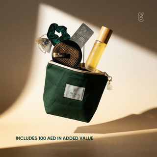 Green makeup bag with skincare products on a beige background