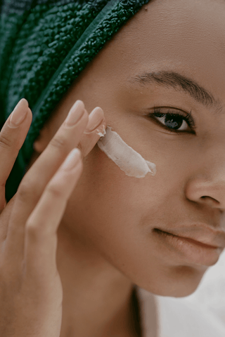 black woman applying tailored freshly created skincare 
