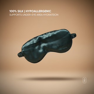 Black silk eye mask on a beige background with text about hypoallergenic properties.