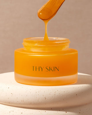 balm in a glass jar and a bamboo spoon